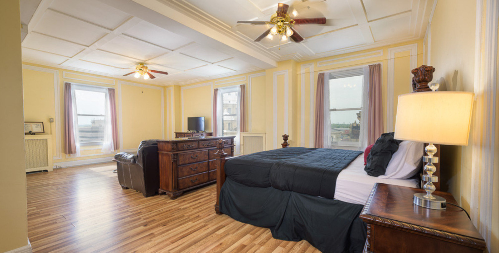a room with a bed and a television