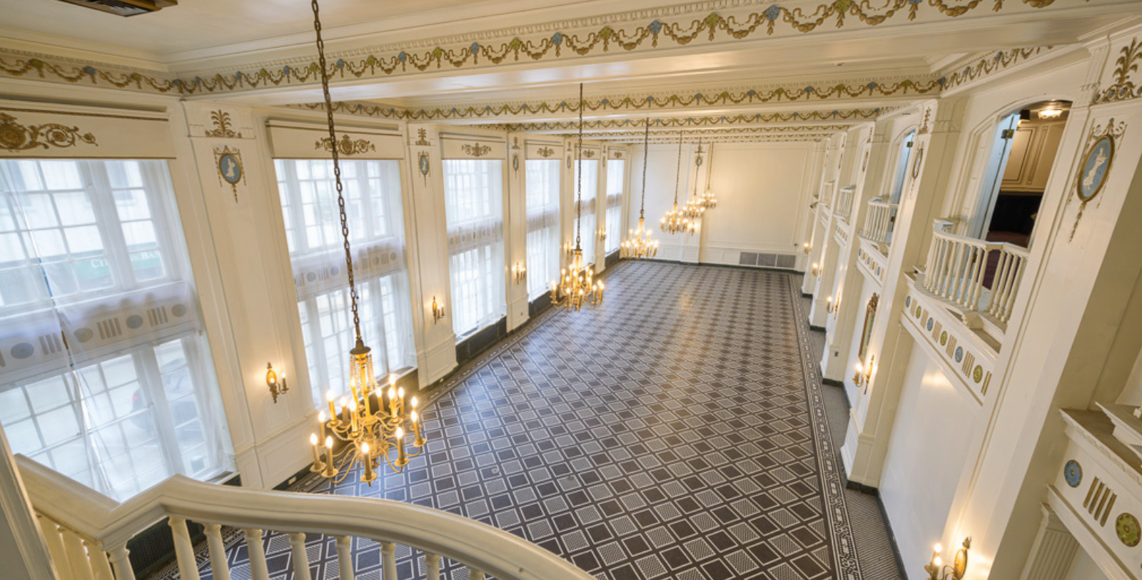 a large room with chandeliers and a staircase