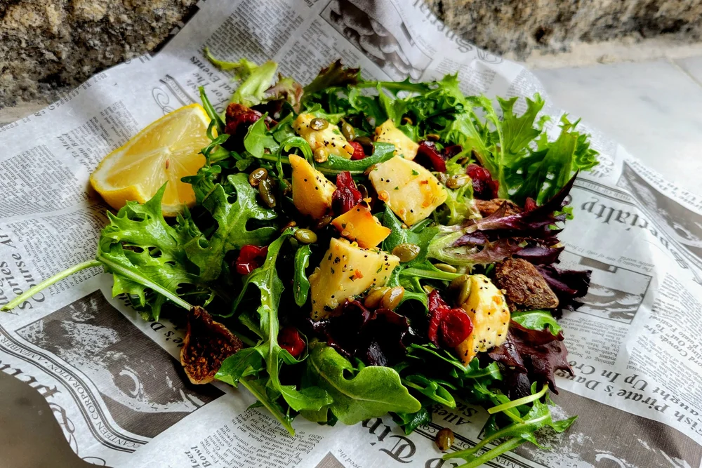 a salad on a newspaper