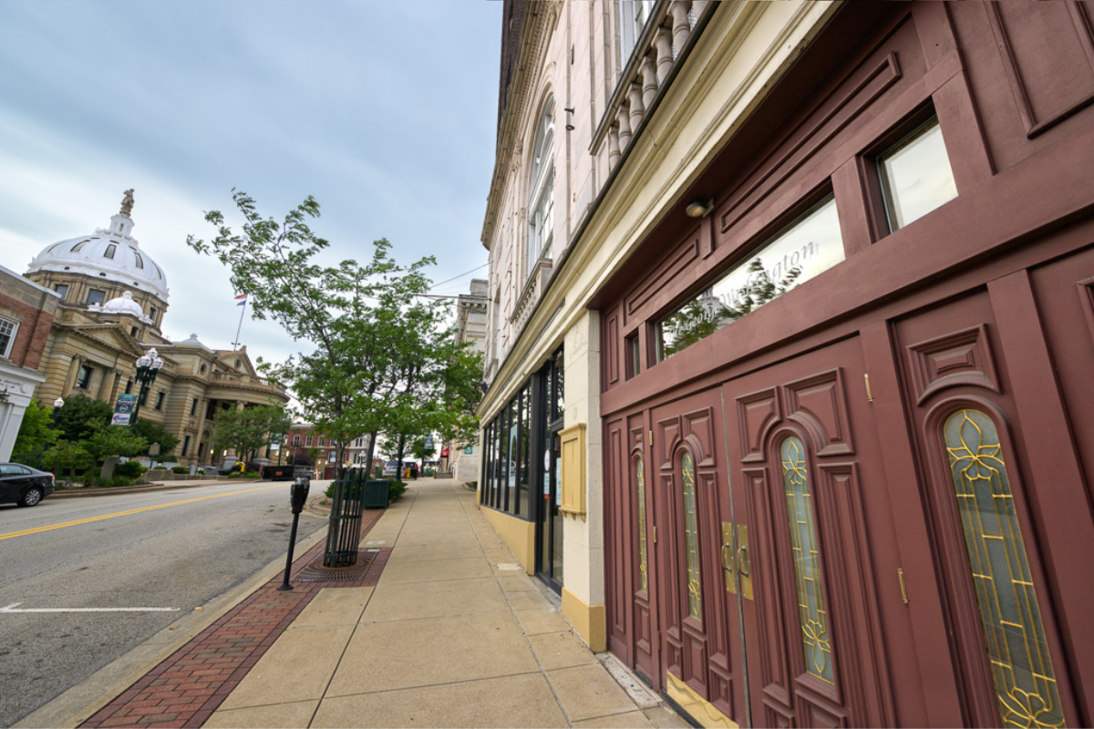 a street with a building and trees