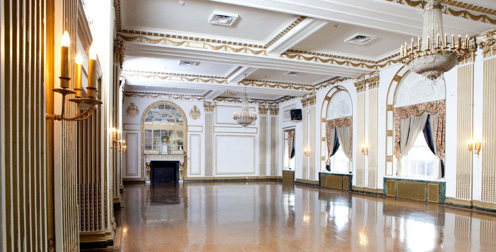 a large room with a mirror and chandelier