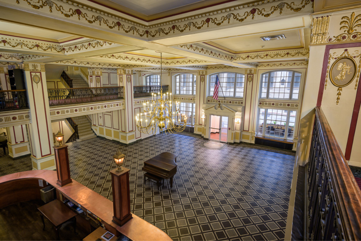 a large room with chandelier and stairs