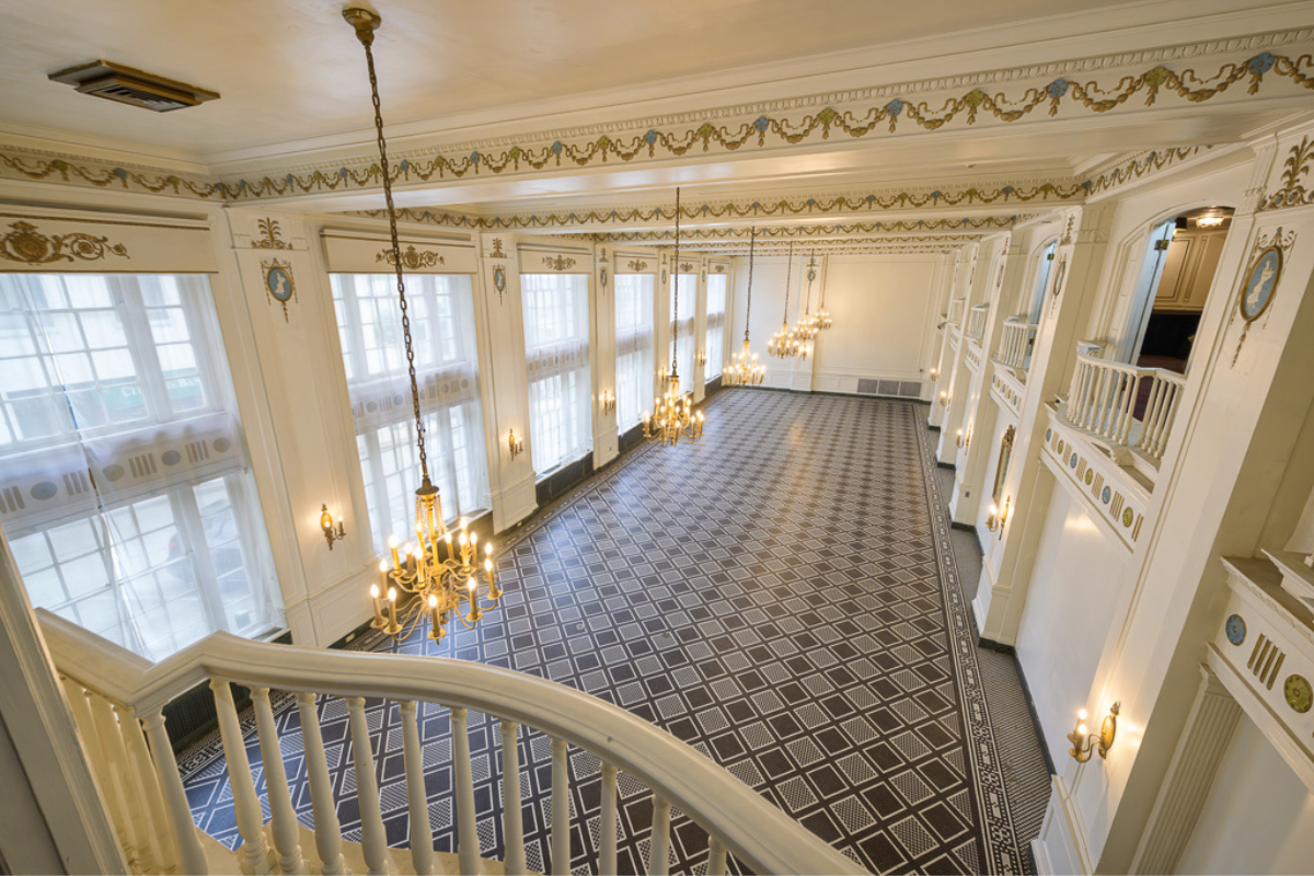 a large room with chandeliers and a staircase