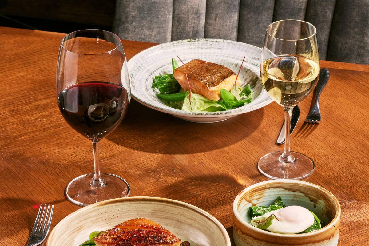 a plate of food and wine on a table