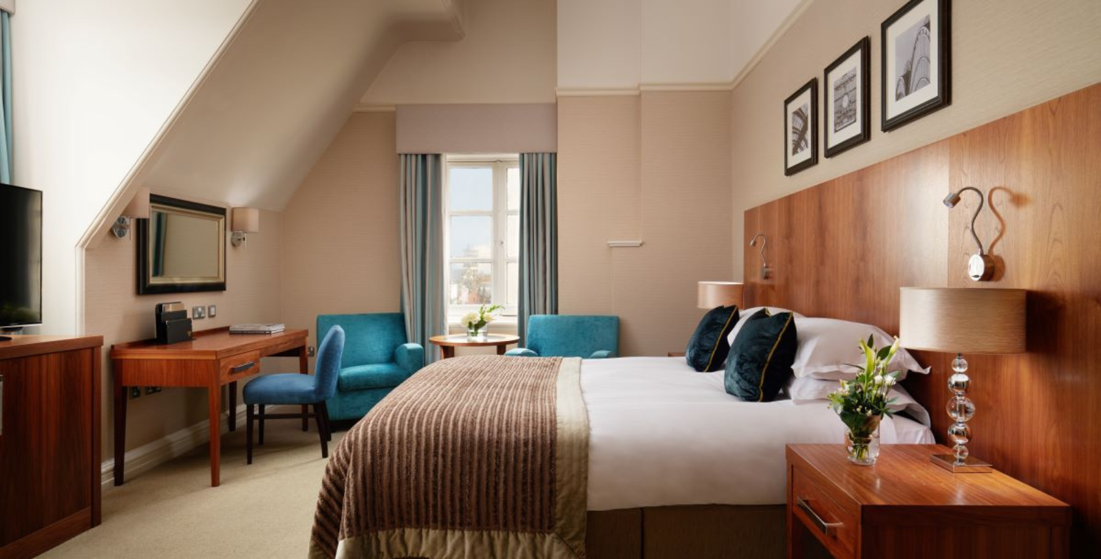 a room with a bed and blue chairs