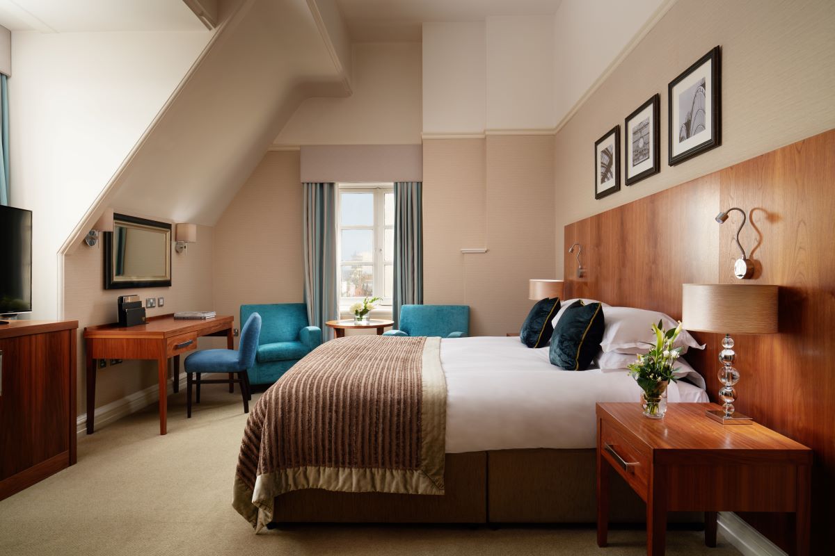 a bedroom with a bed and a desk