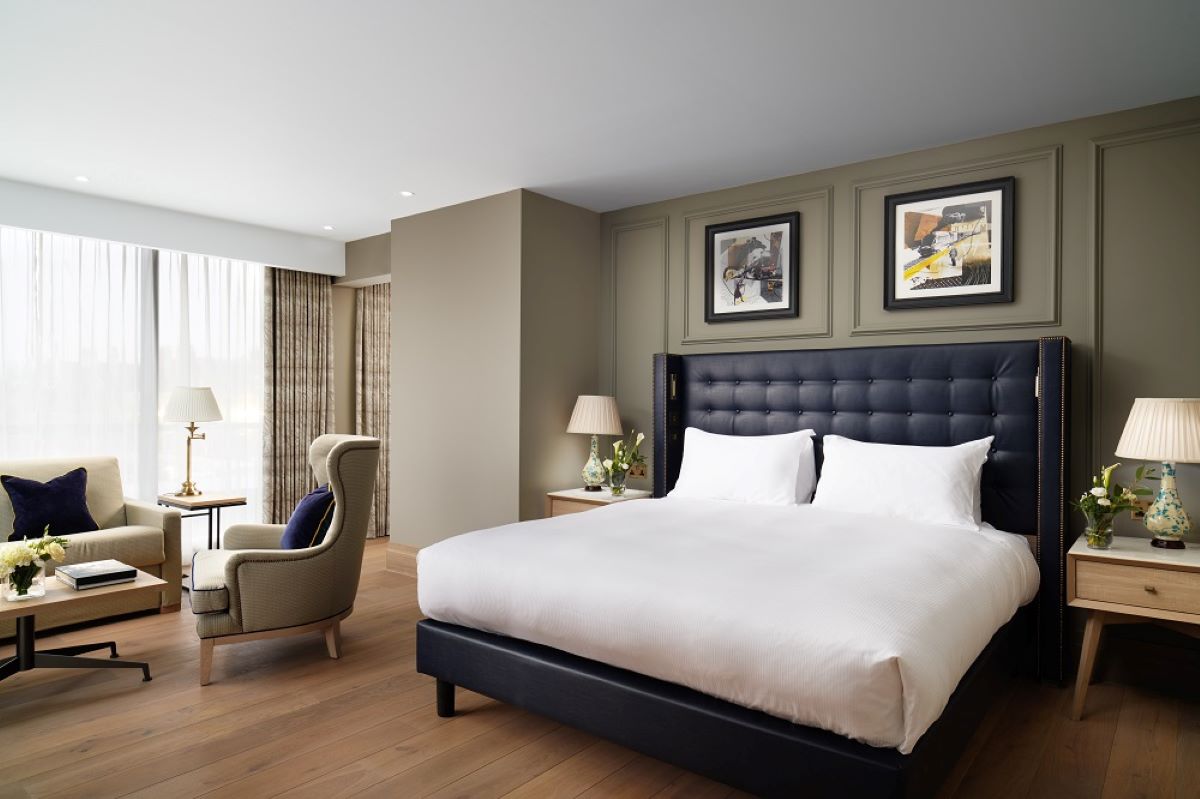 a bedroom with a bed and a chair