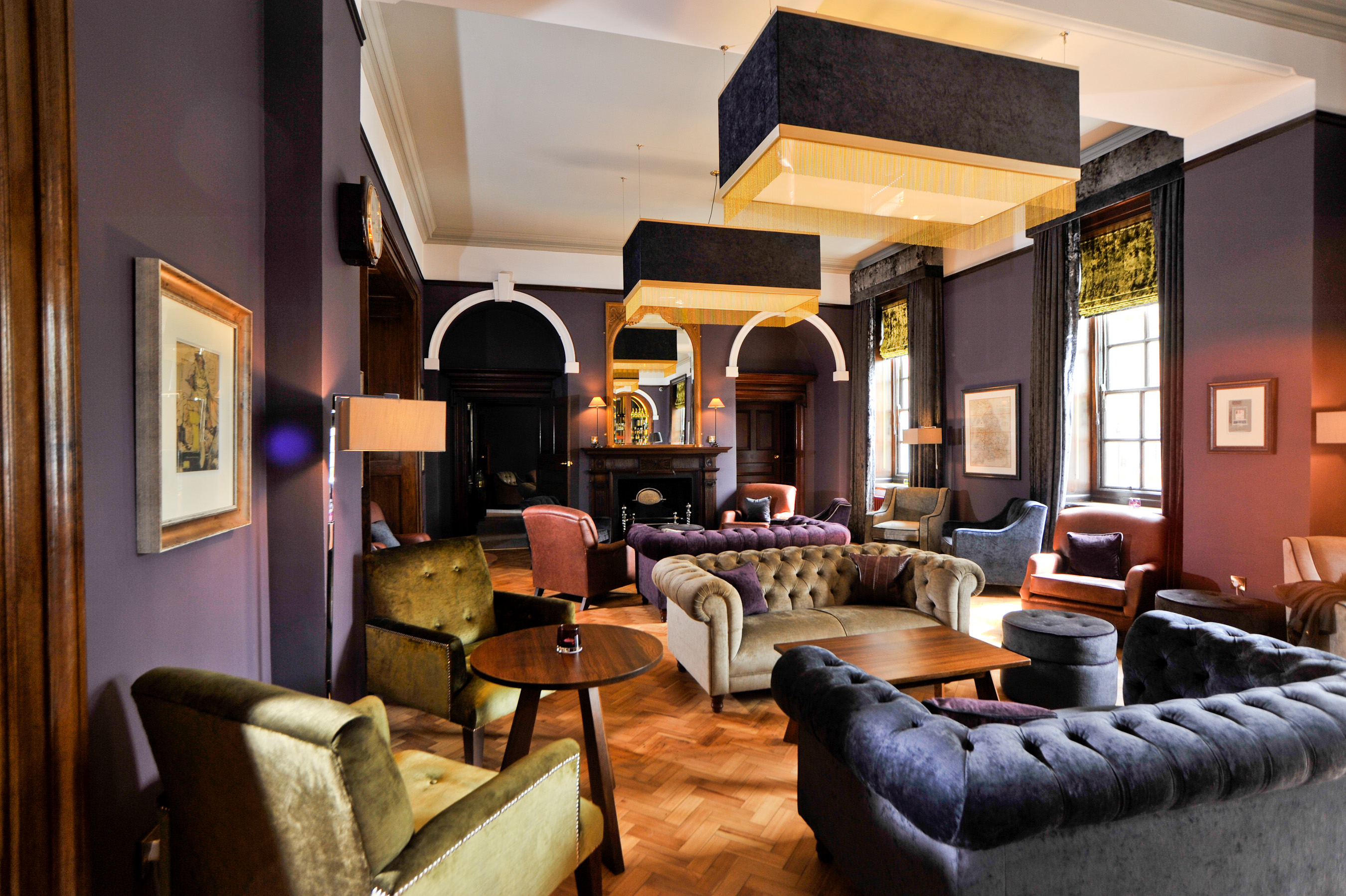 a room with purple walls and couches