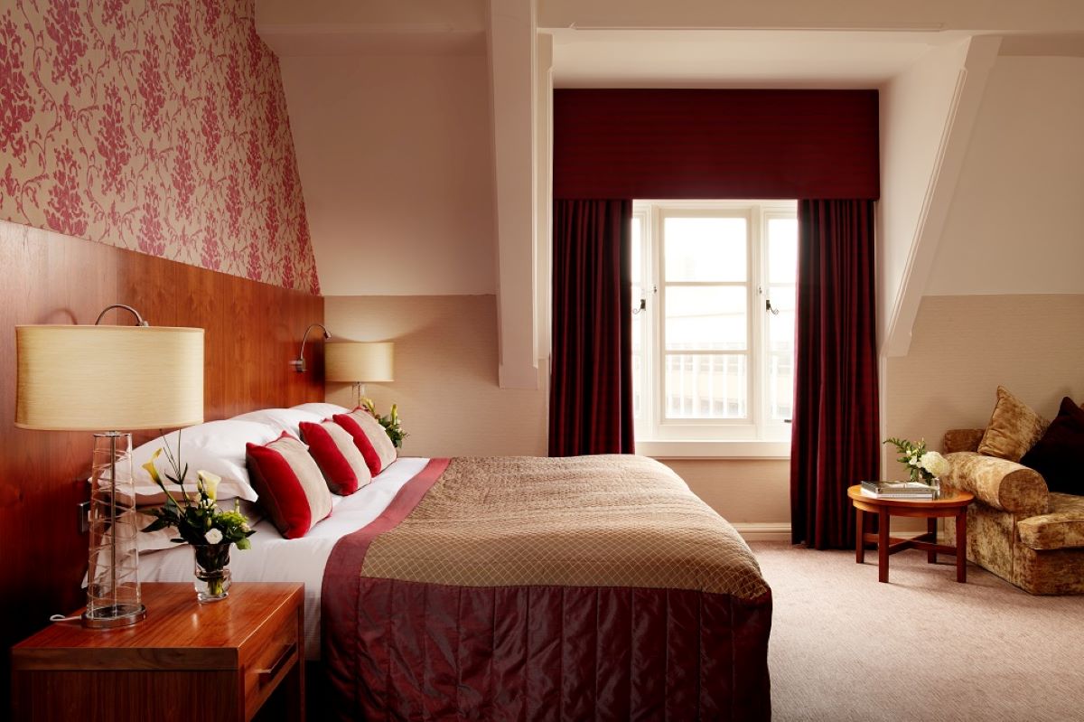 a bedroom with a bed and a table