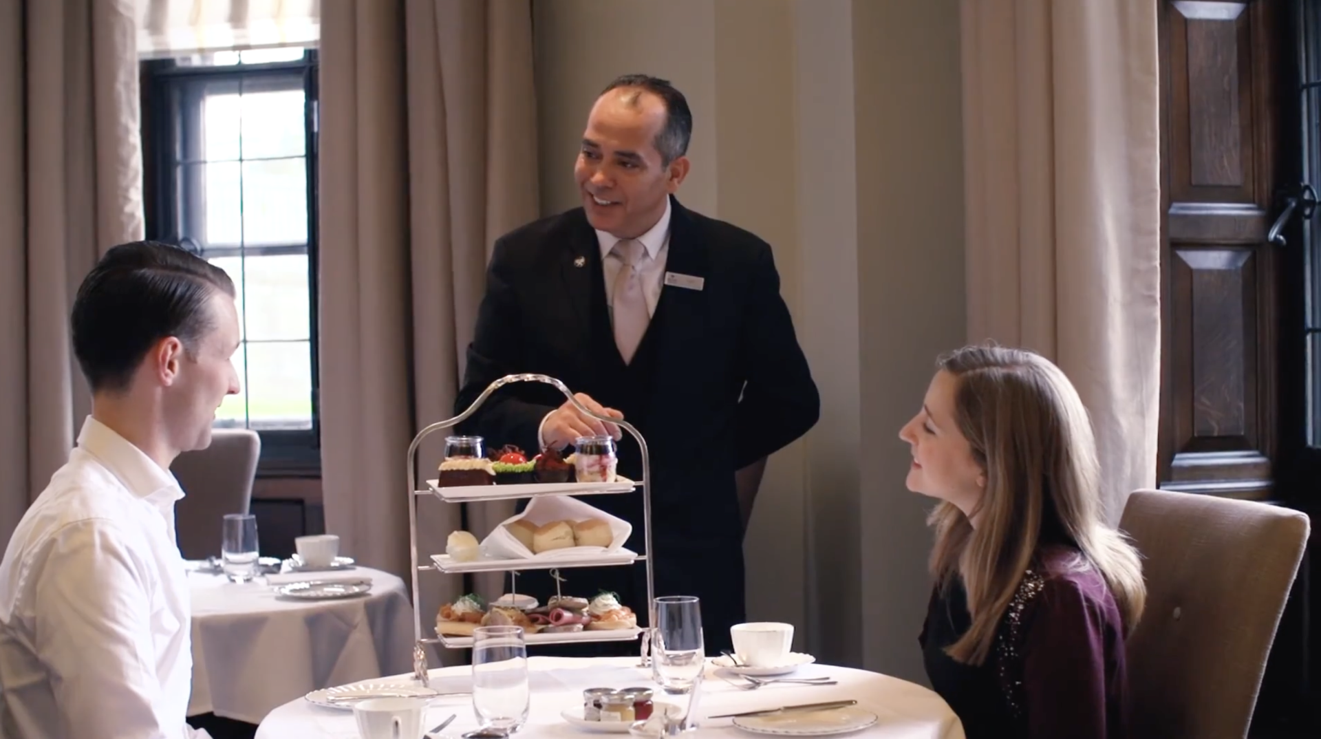 a man serving food to a woman