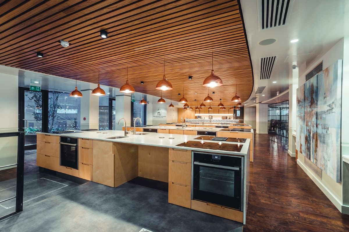 a large kitchen with wooden cabinets and lights