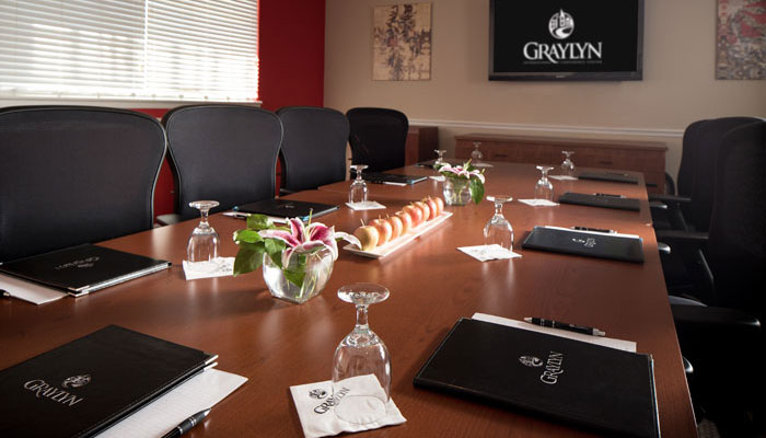 a conference room with a table with glasses and fruit