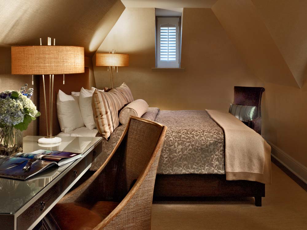 a bedroom with a bed and a desk