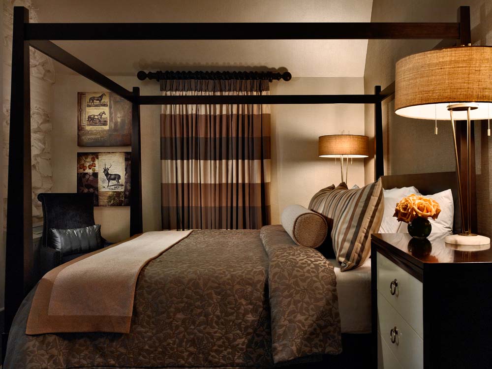 a bed with a four poster bed