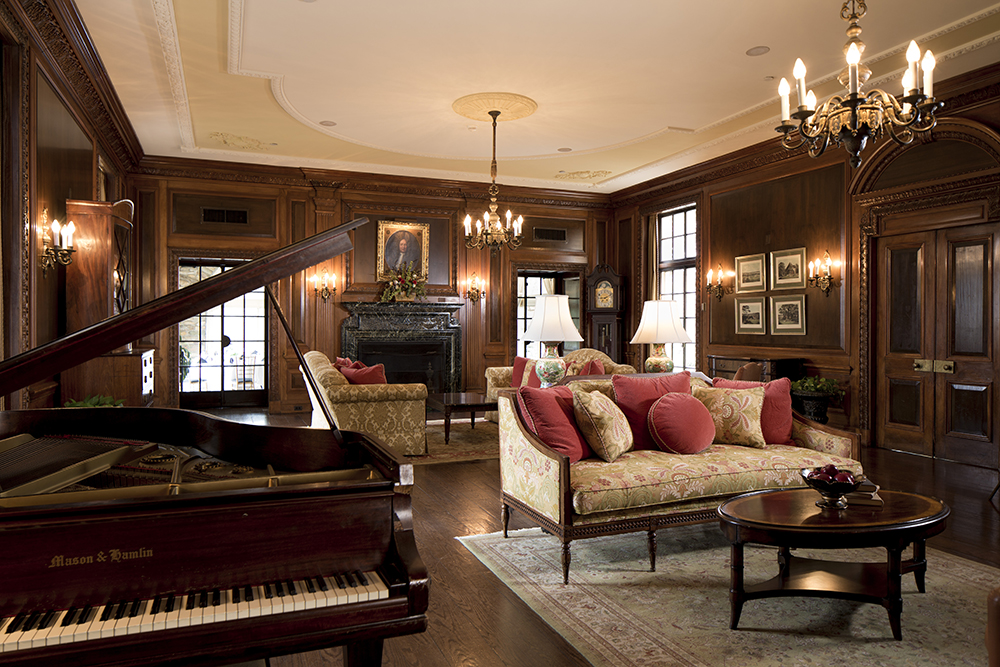 a living room with a piano and couches
