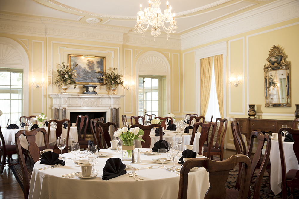 a room with a chandelier and tables set up
