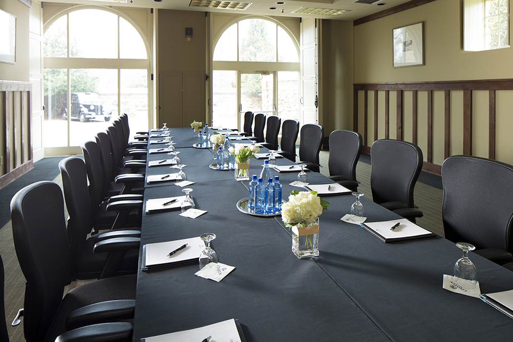 a long table with black cloth and white flowers on it