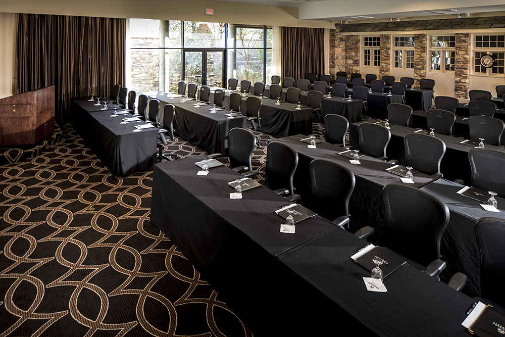 a room with black tables and chairs