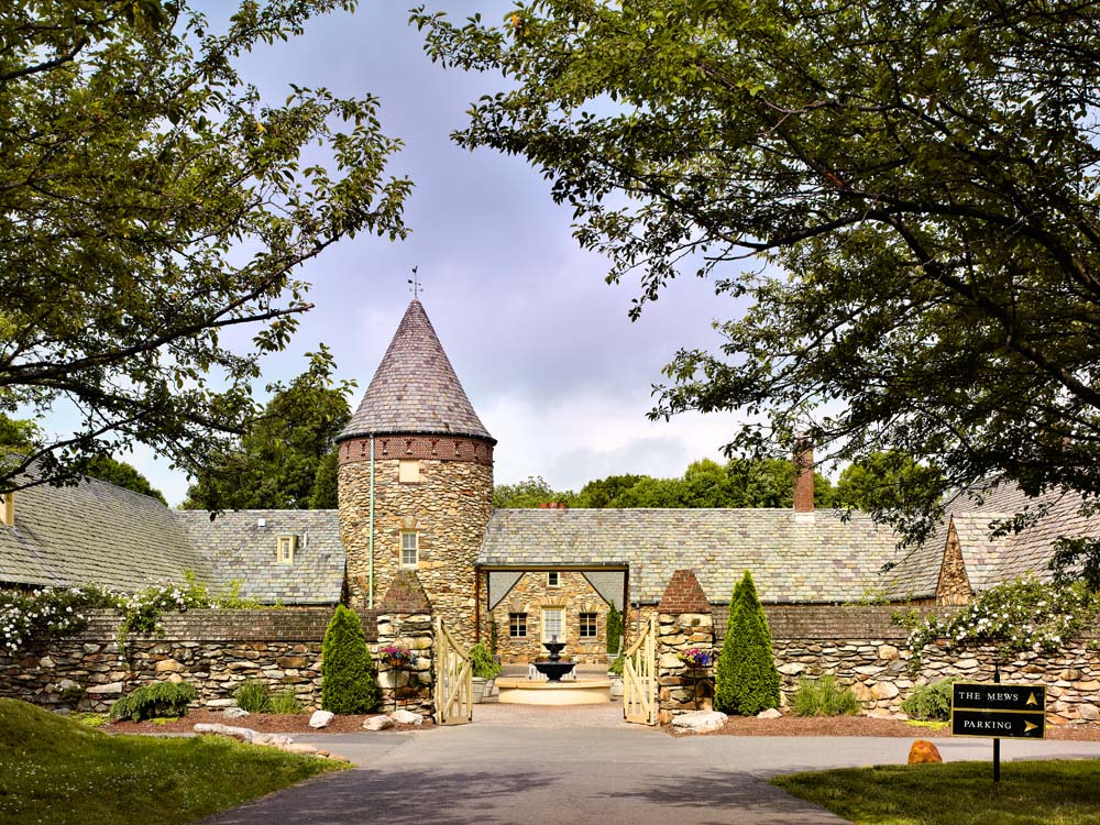 a stone building with a tower and a fountain