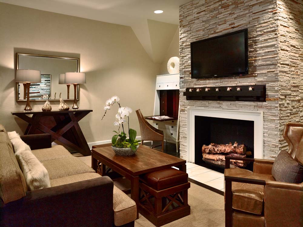 a living room with a fireplace and a television