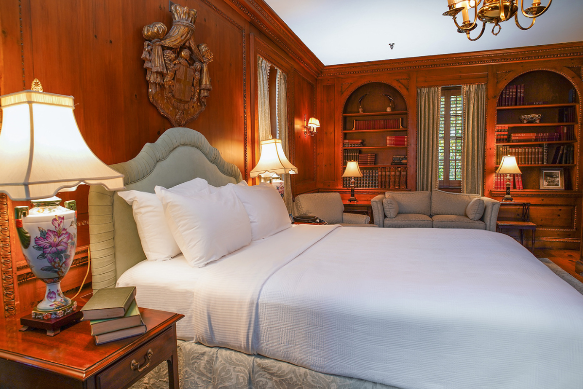 a room with a bed and a bookcase