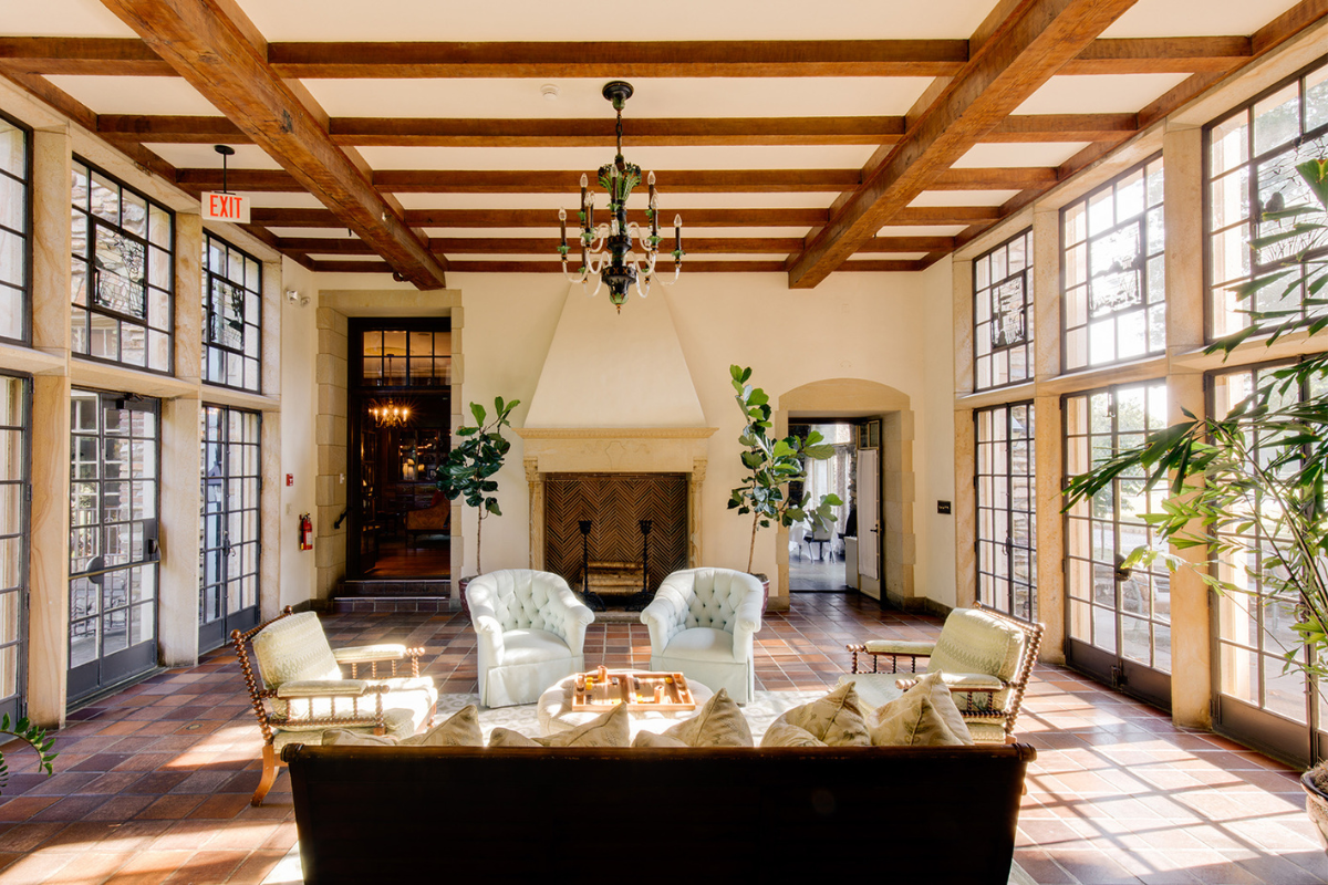 a room with a fireplace and chairs