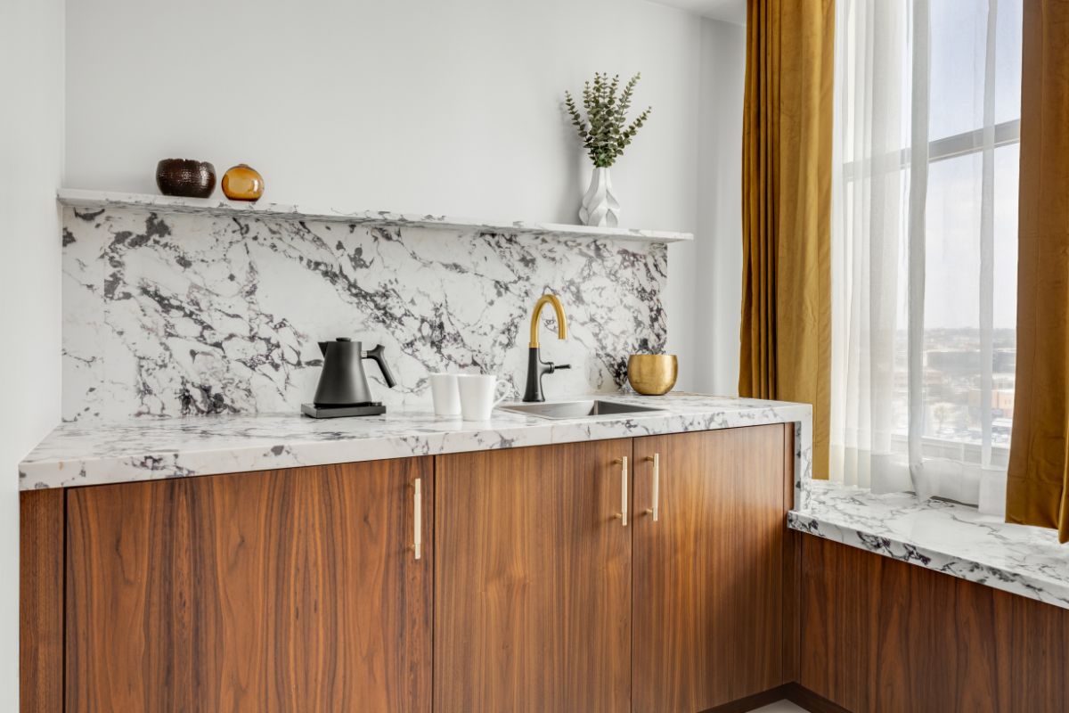 a kitchen with marble counter tops and a sink