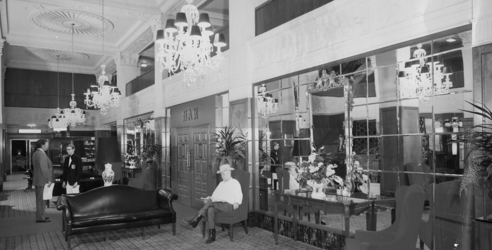a man sitting in a chair in a lobby