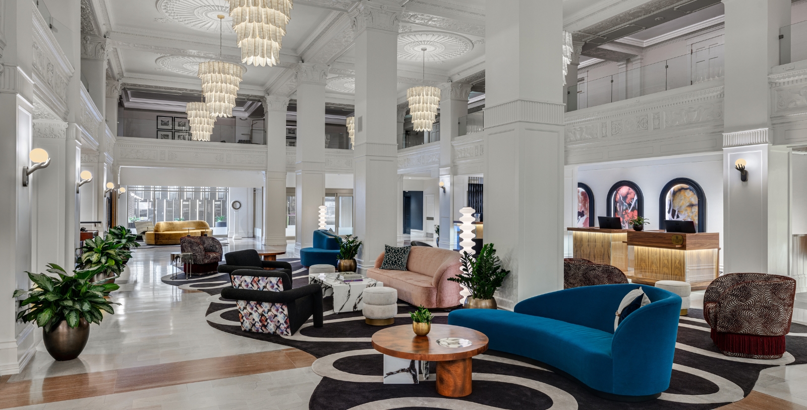 a large lobby with a large chandelier and couches