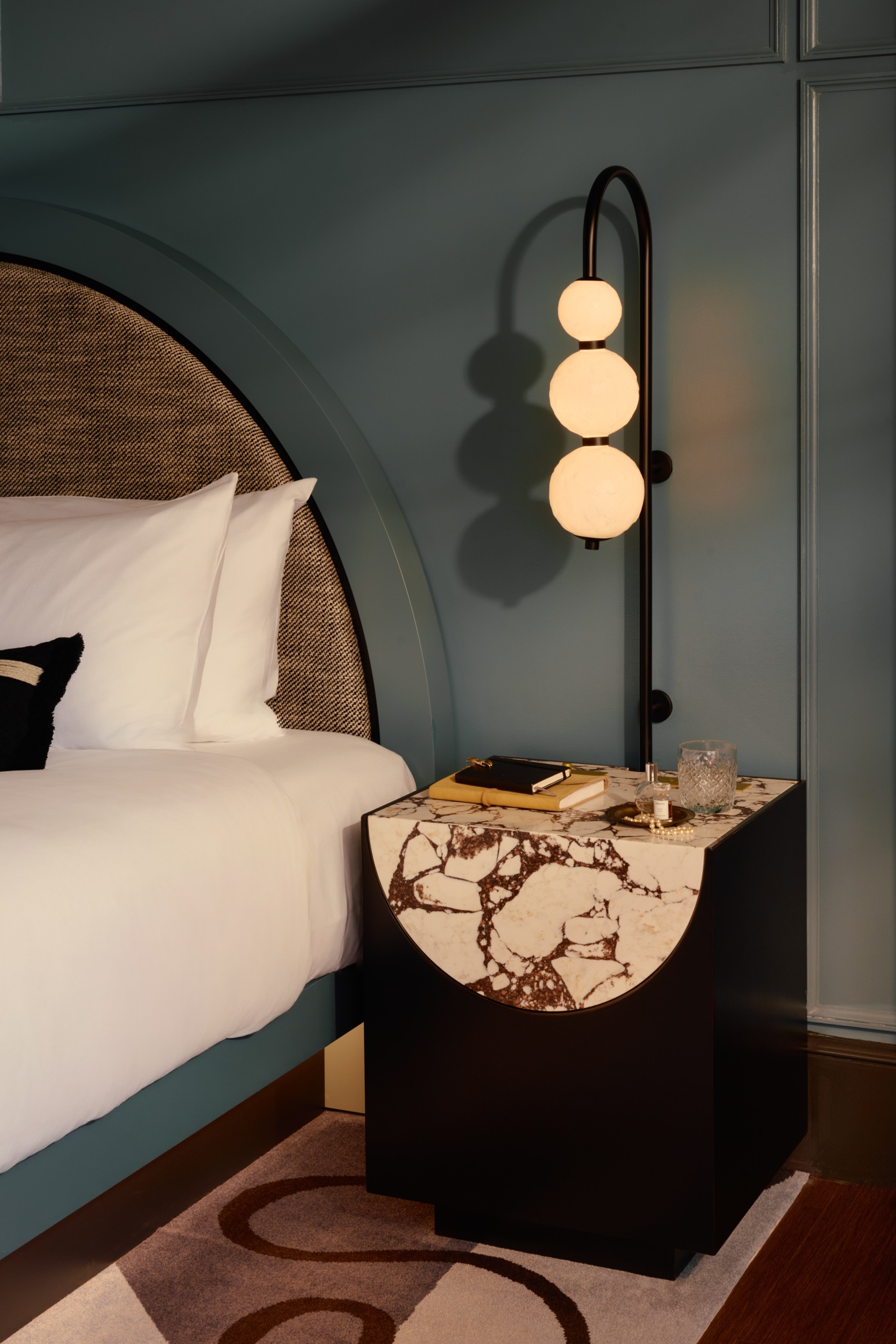 a lamp next to a bed