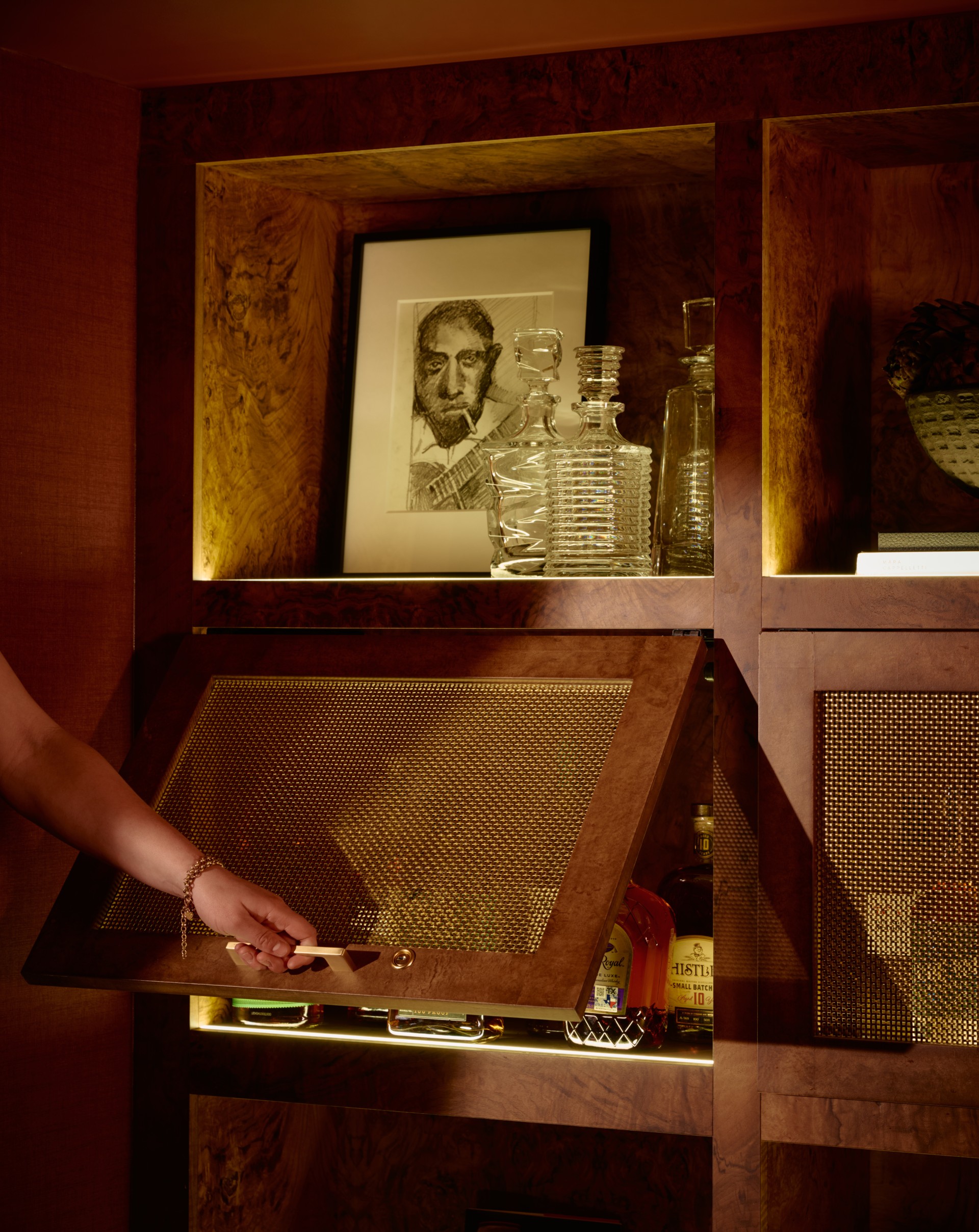 a person opening a cabinet