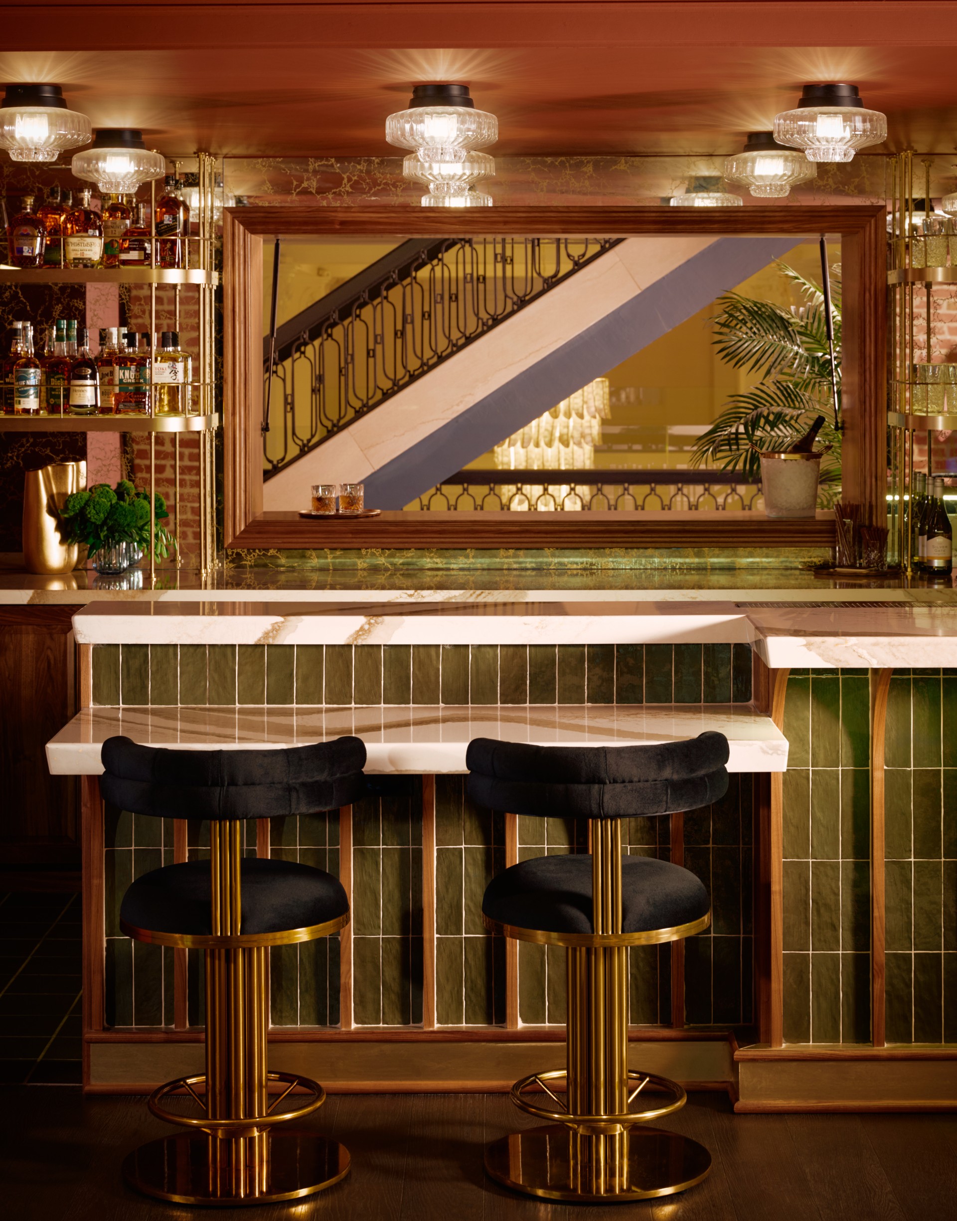 a bar with stools and a mirror