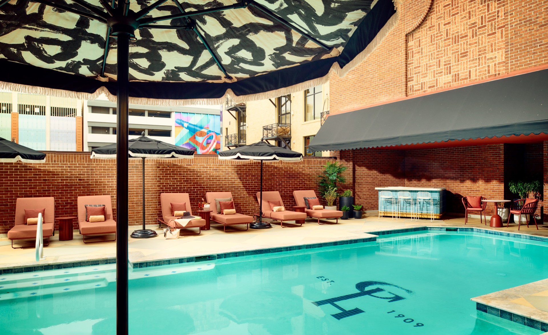 a pool with chairs and umbrellas