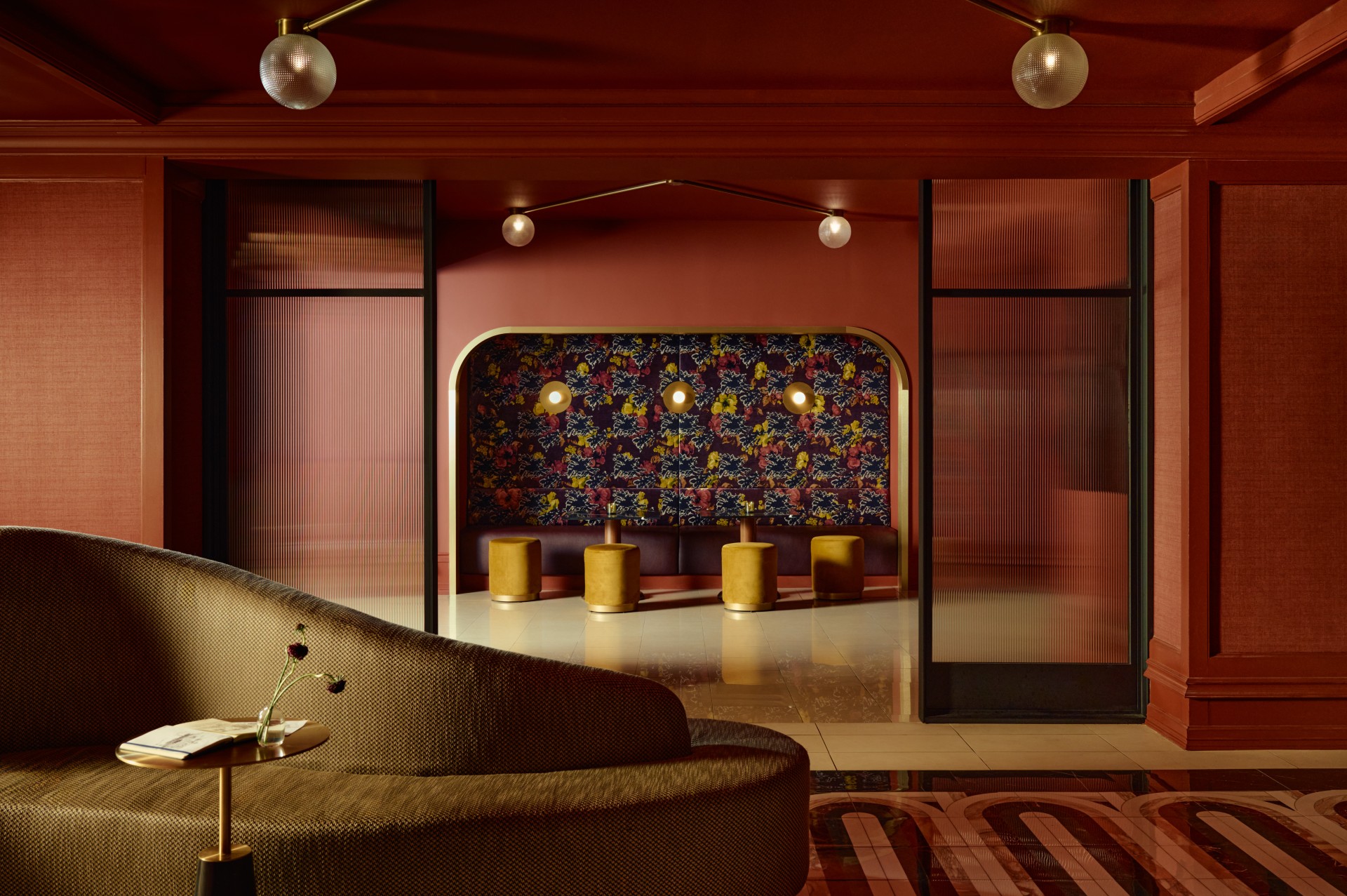 a room with a floral wall and chairs