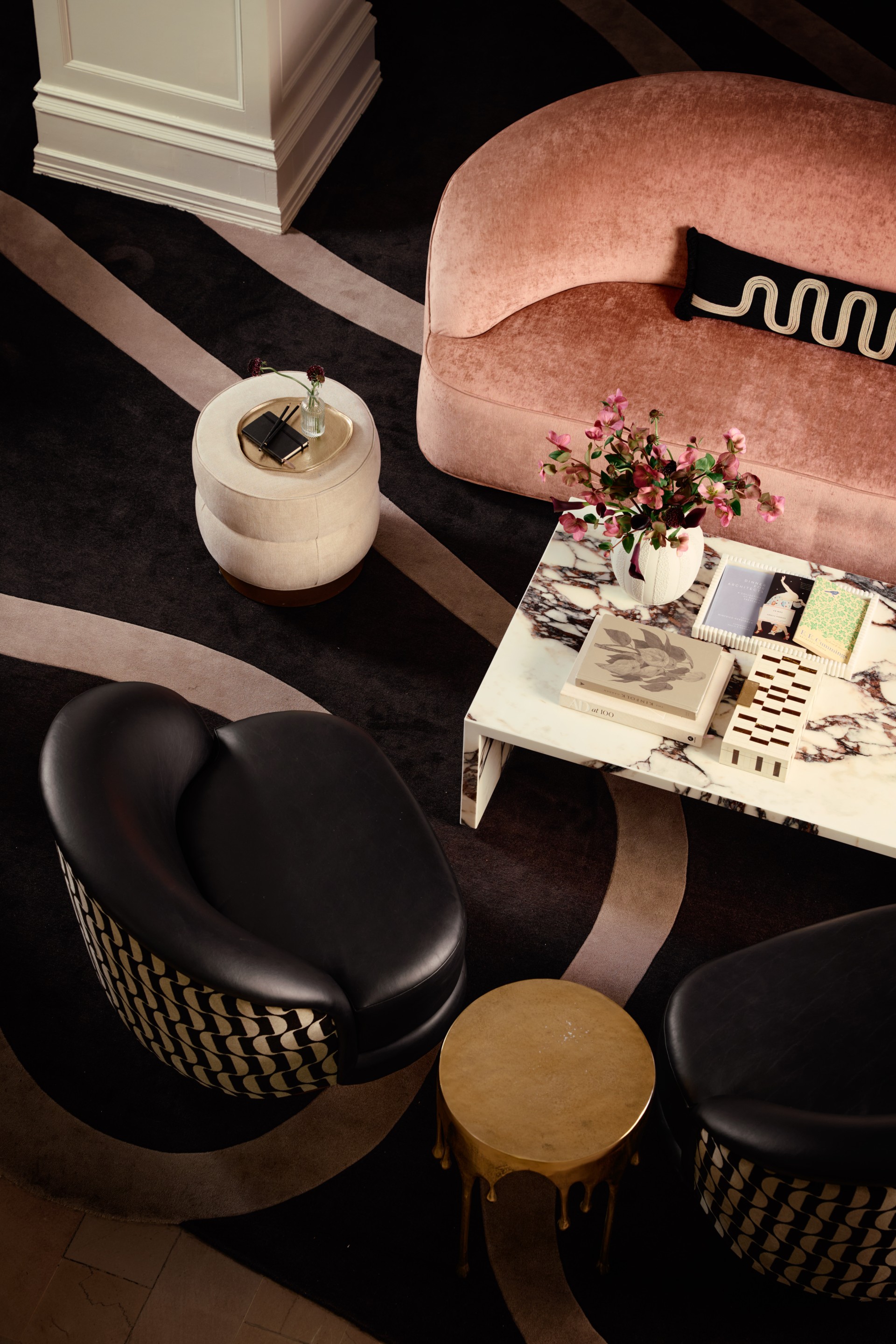 a living room with a pink couch and a coffee table
