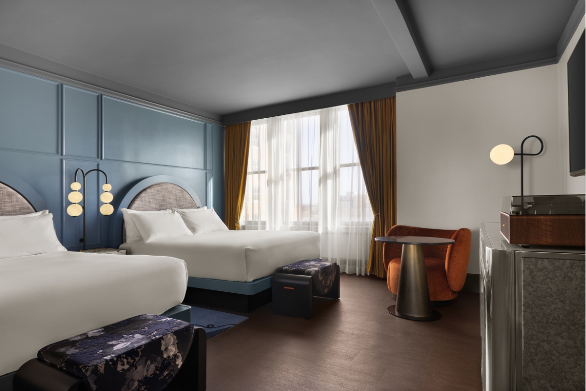 a room with two beds and a table