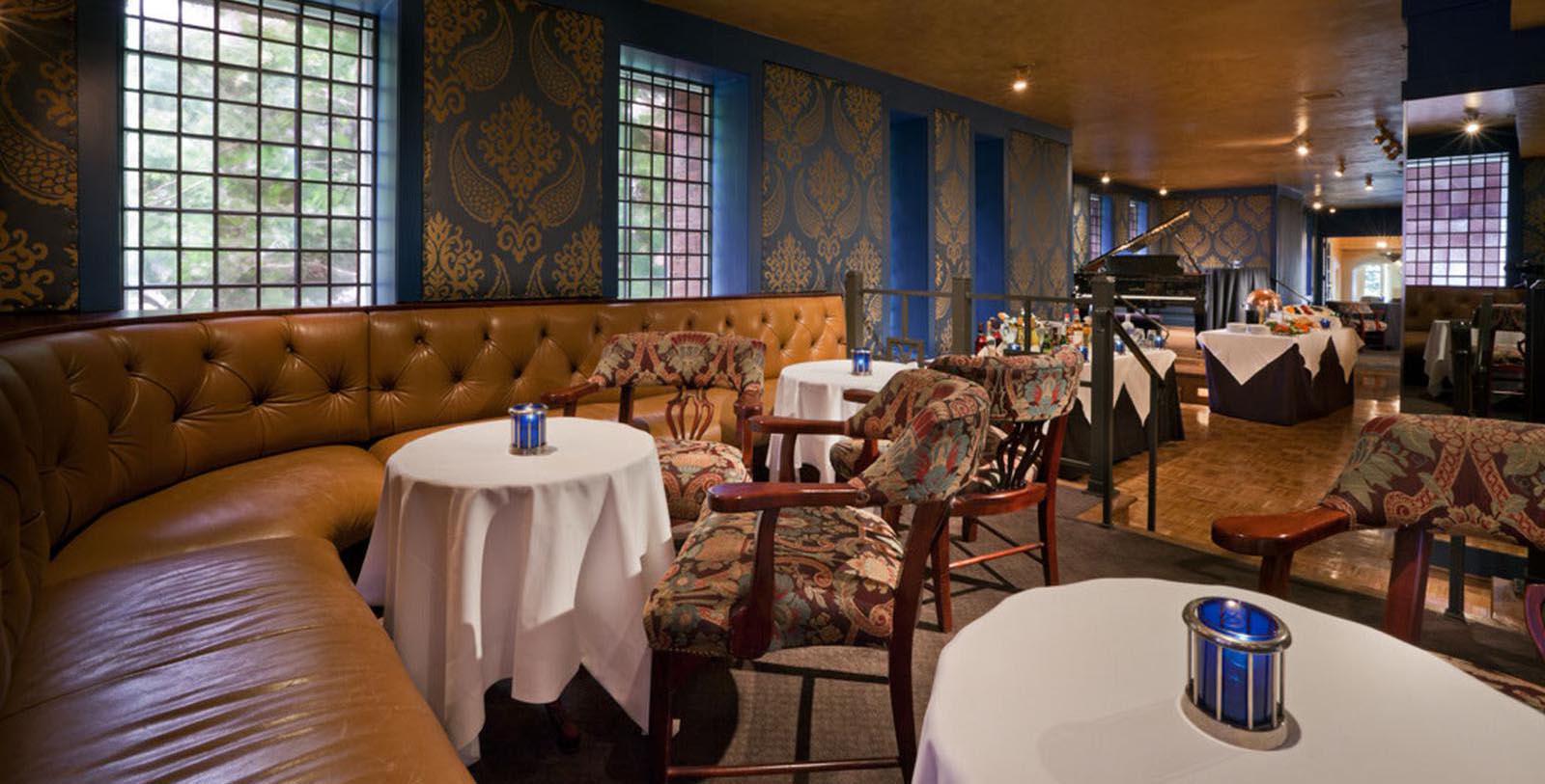 a room with a piano and tables