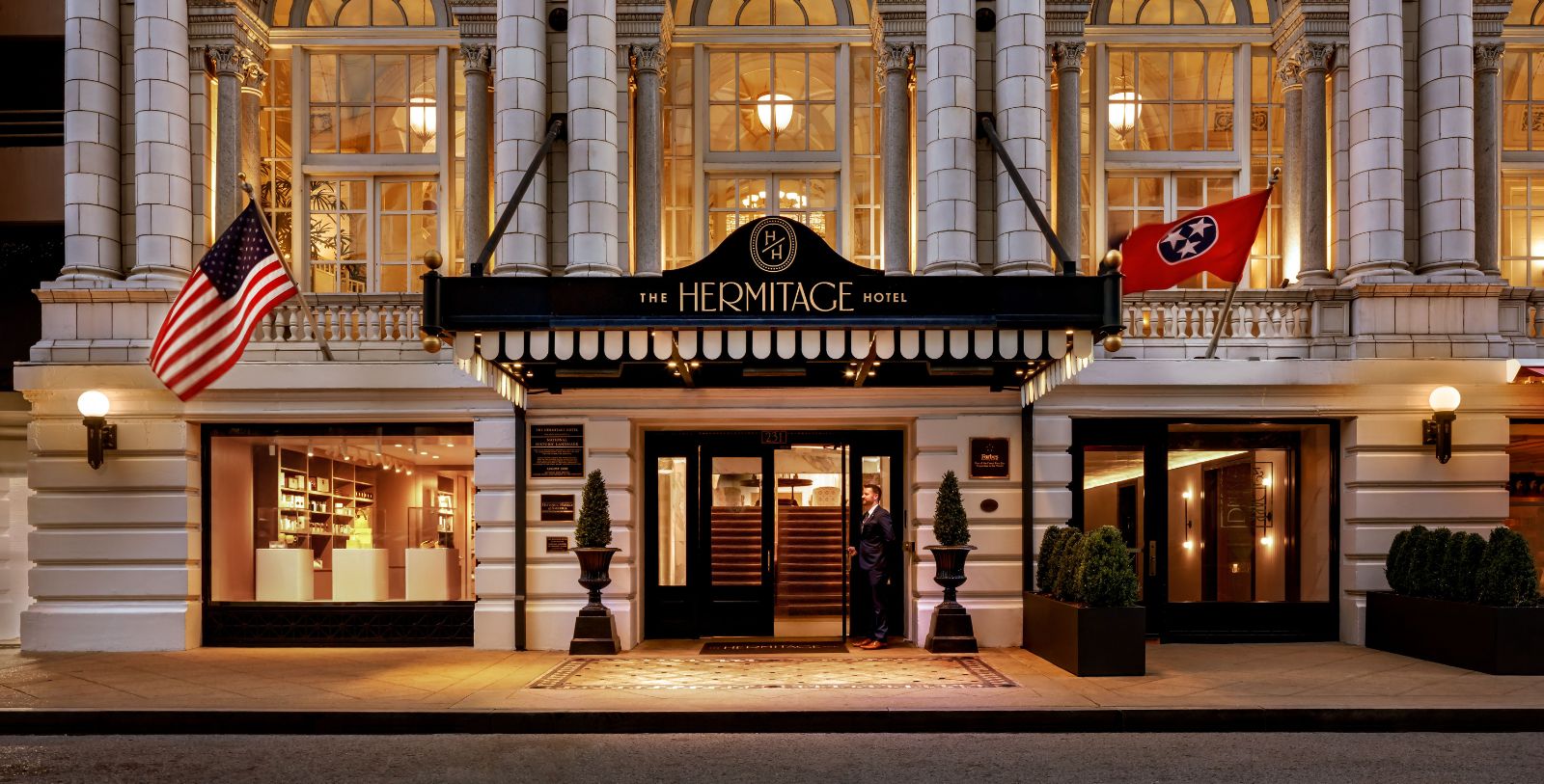 a man standing in front of a hotel