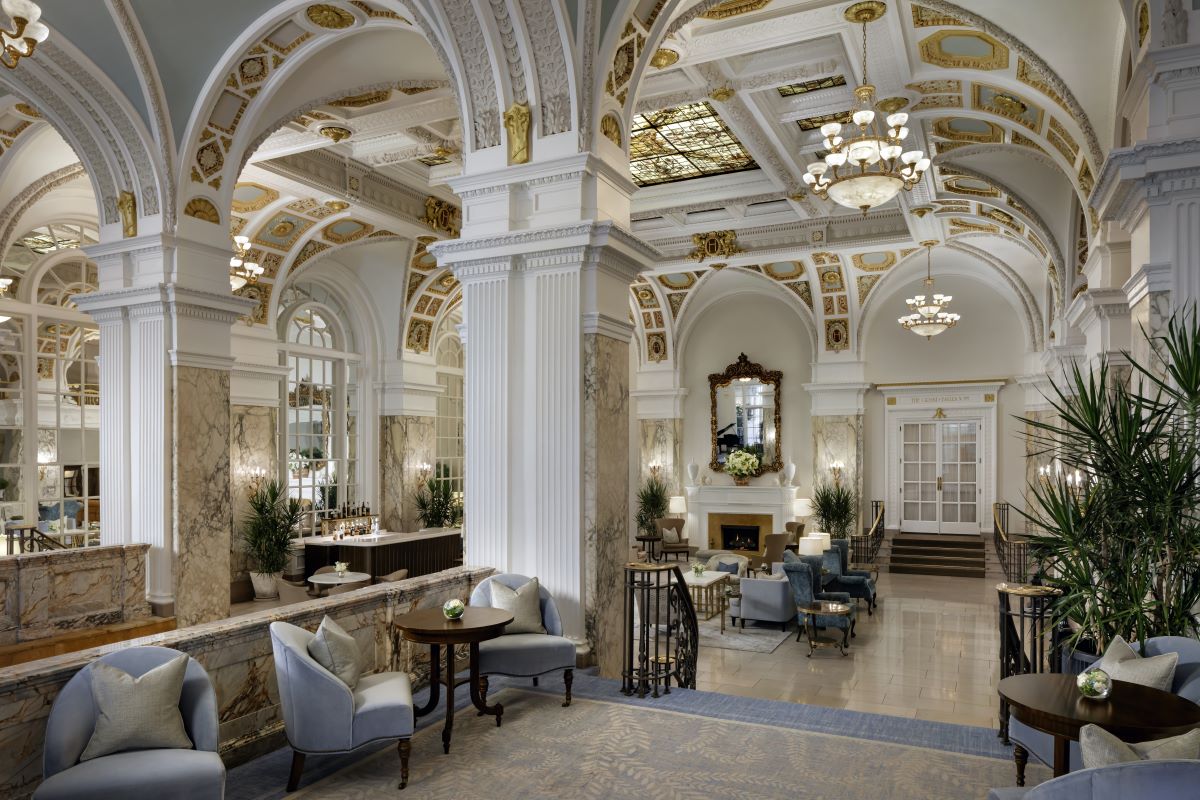 a room with a large ceiling and a large fireplace