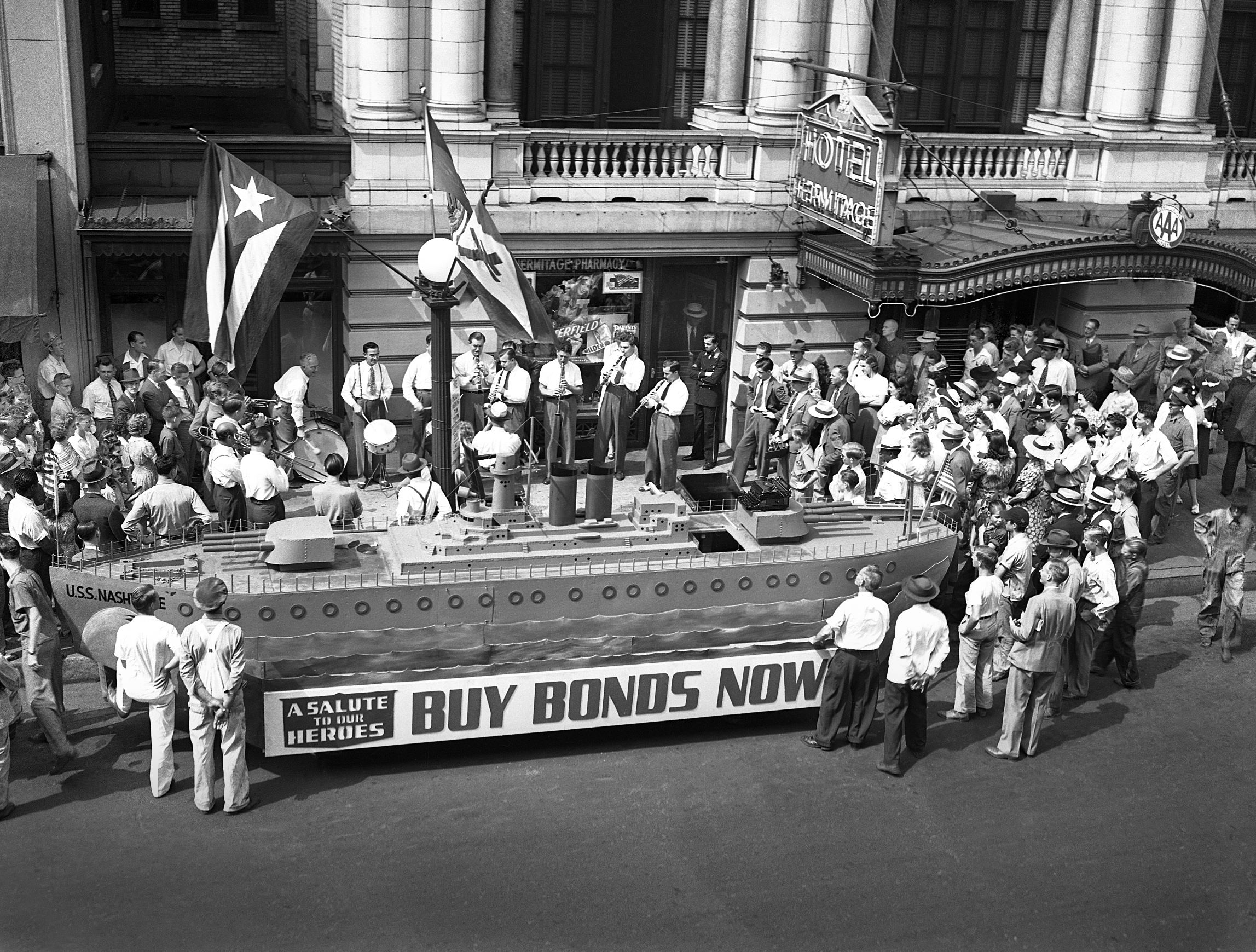 a group of people standing in front of a parade