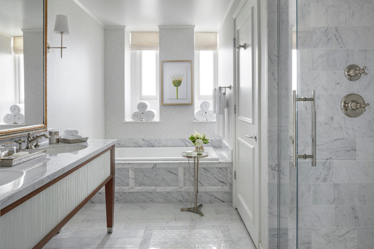 a bathroom with marble floor and white walls