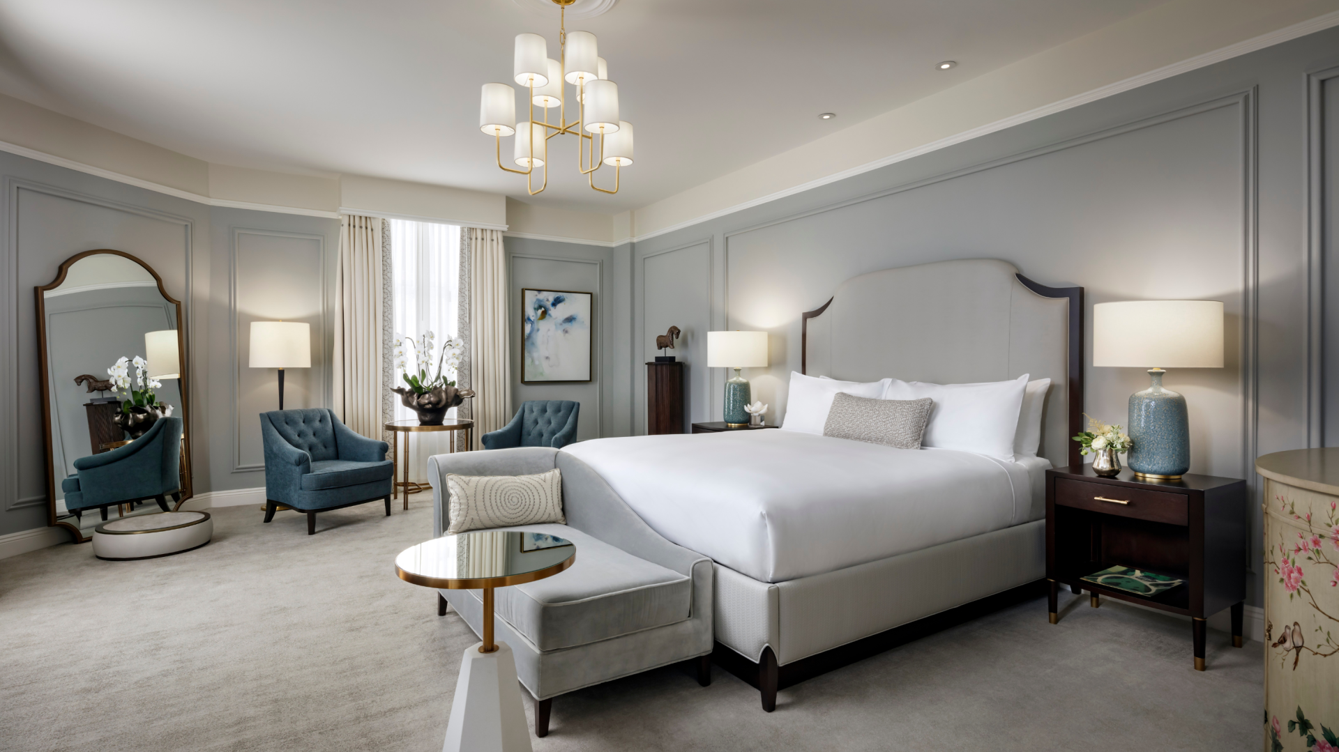 a bedroom with a bed and chairs