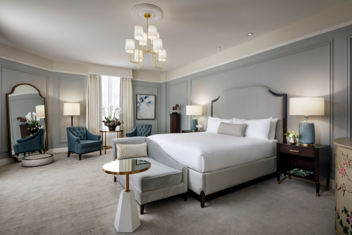 a bedroom with a bed and chairs