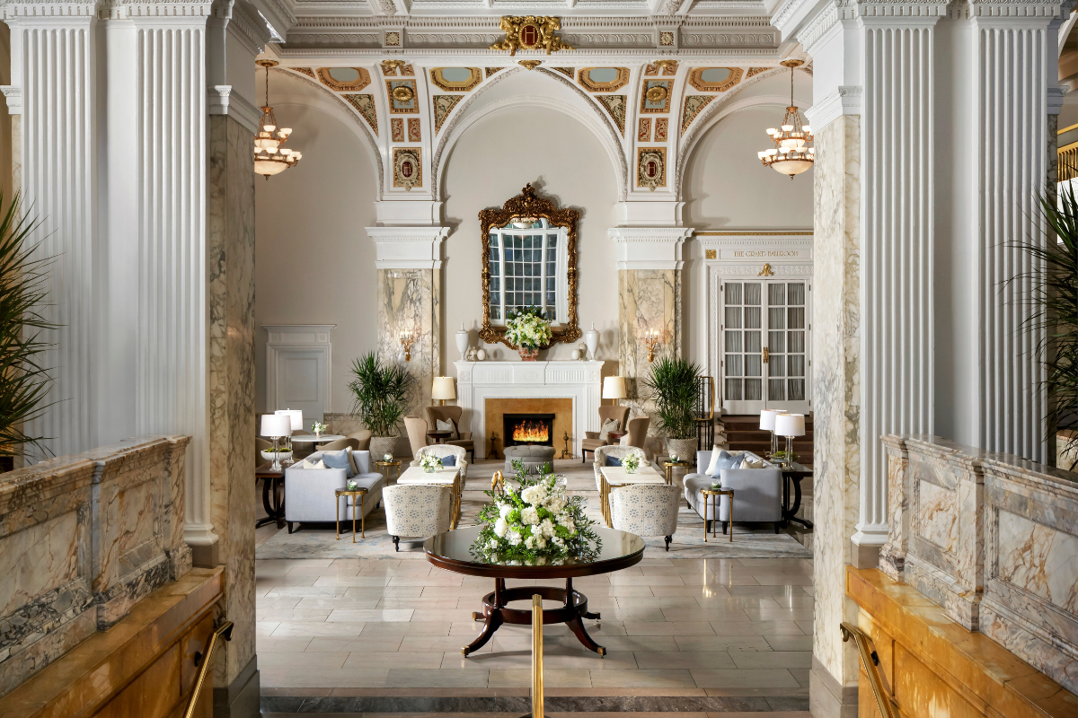 a room with a fireplace and tables