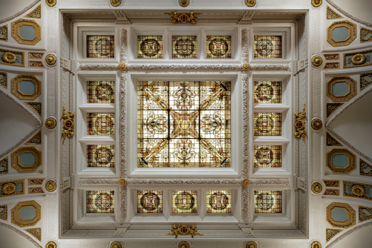 a stained glass ceiling with gold trim