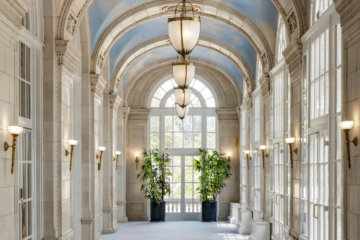a hallway with a large window and a large chandelier