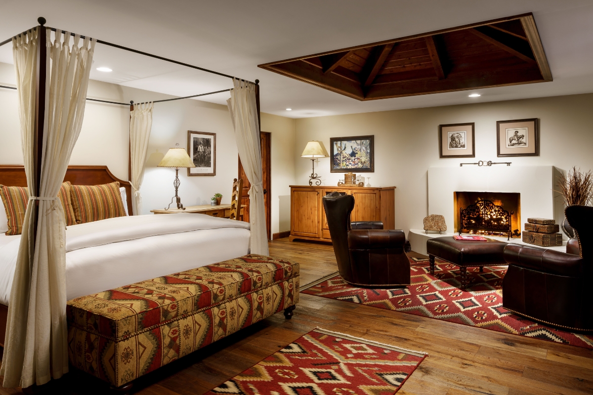 a room with a bed and a fireplace