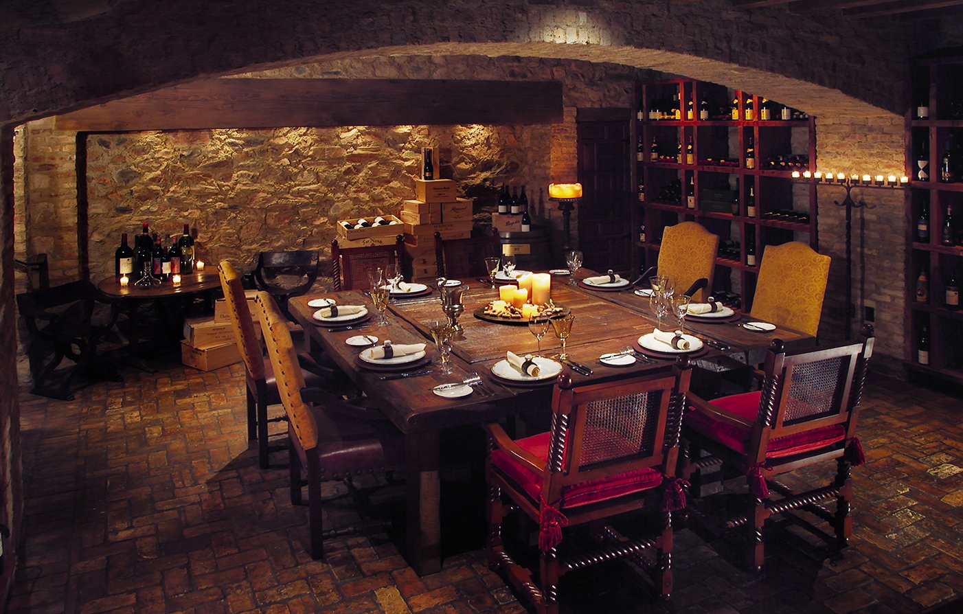 a table with candles and wine glasses