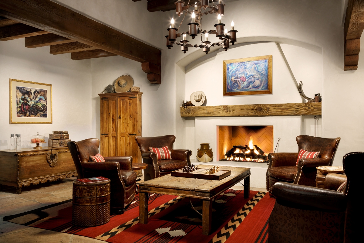 a room with a fireplace and chairs