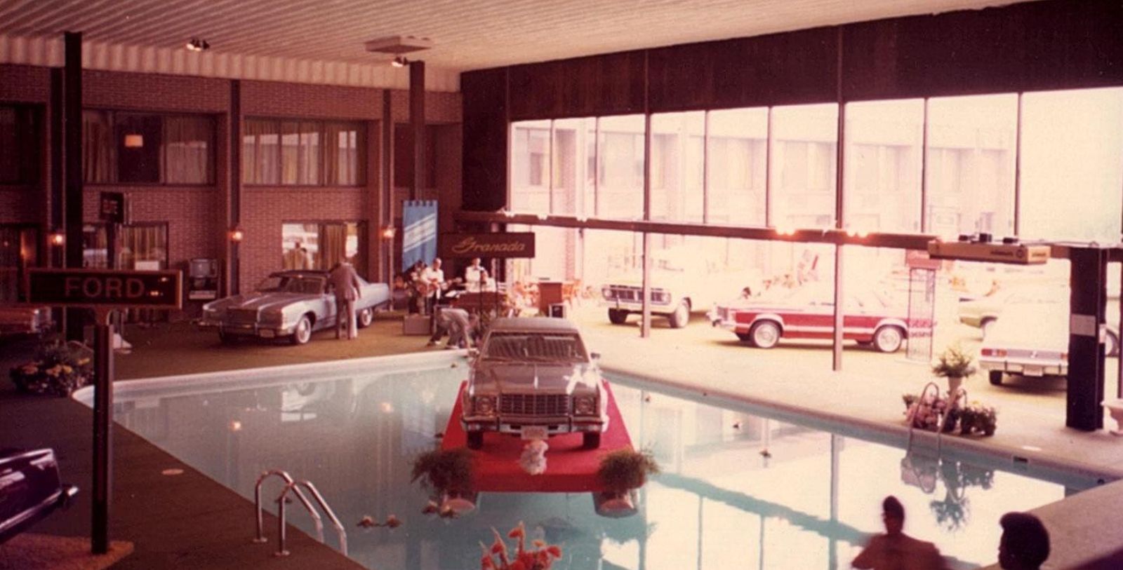 a pool with cars and people around it